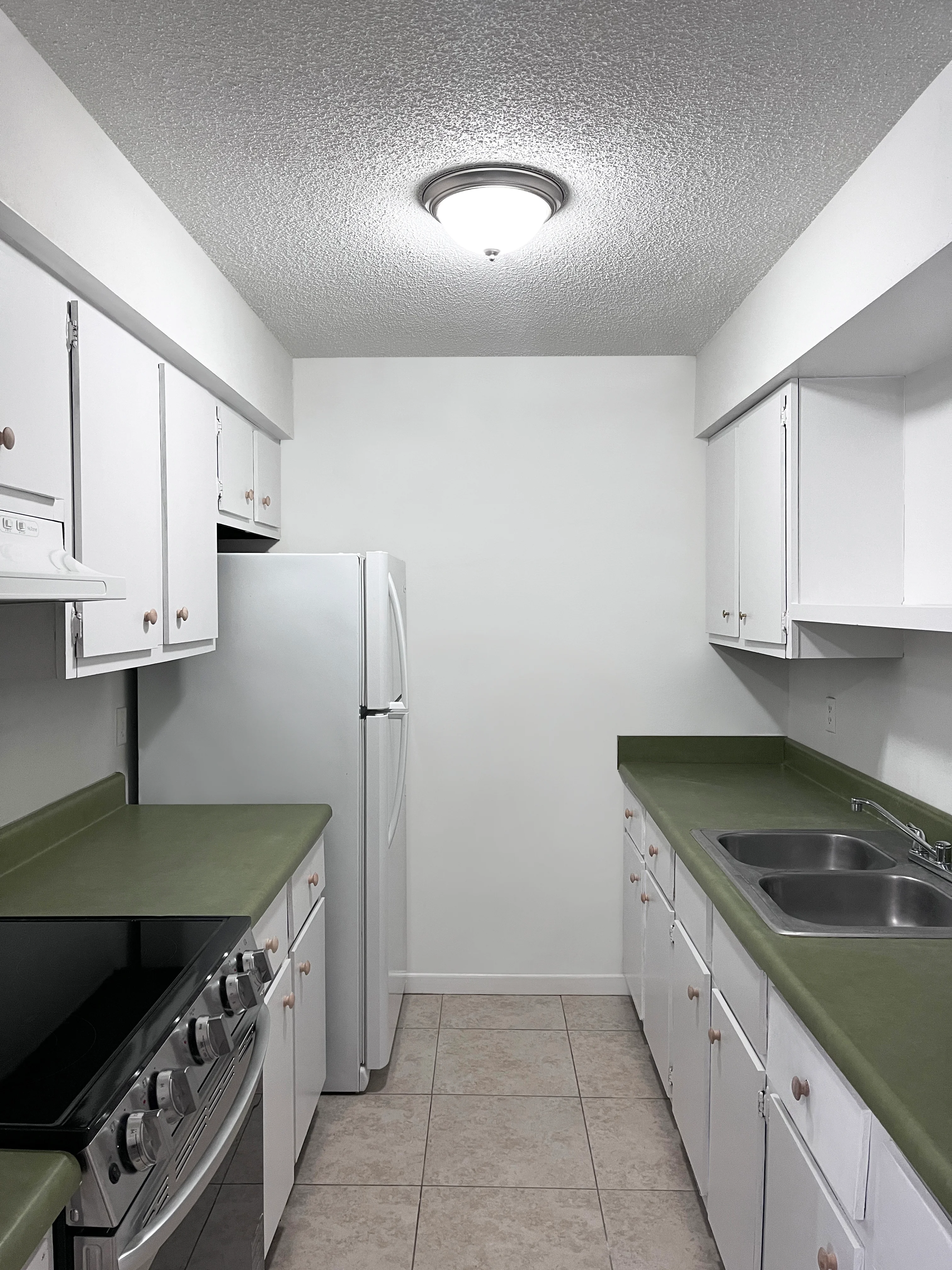 Apartment kitchen with white cabinets